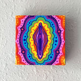 NSFW canvas panting of a colorful reproductive organ with a rainbow background. Art from Osseous Design by independent artist Makena Peet.