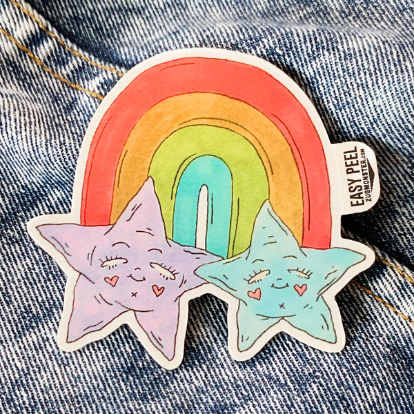 Two stars with faces sitting under a rainbow on vinyl with a matte finish and easy peel tab. This sticker is waterproof, UV-resistant, and able to withstand excessive handling. From Osseous Design by independent artist Makena Peet.
